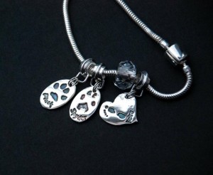 Silver paw and footprint charms on bracelet