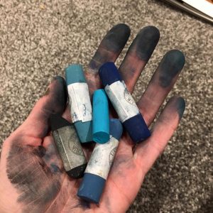 photograph of pastels in artists hand